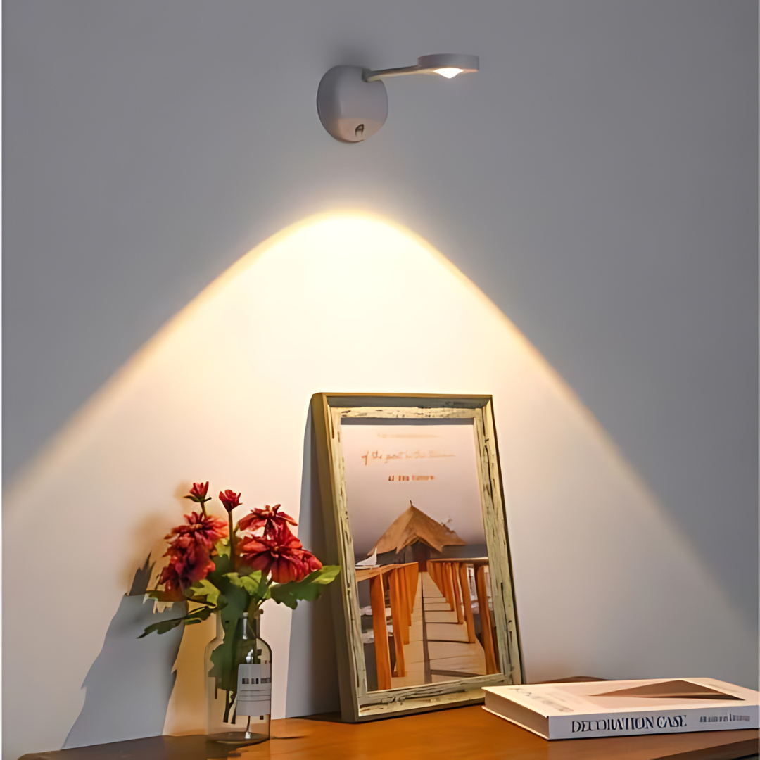 White motion sensor spotlight mounted above a decorative table setting with flowers
