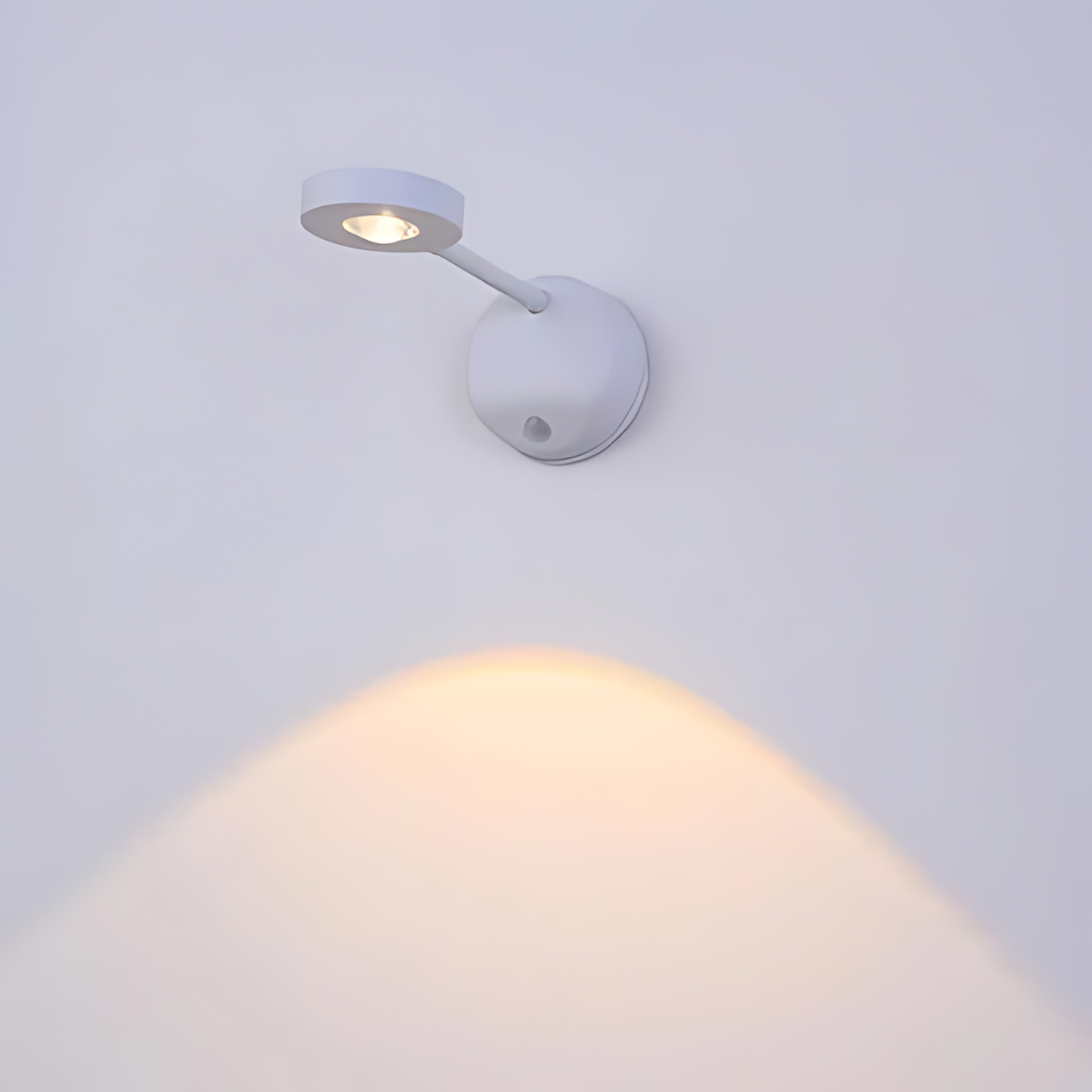 Close-up view of the wireless lamp showing its sleek white casing and motion detection lens.