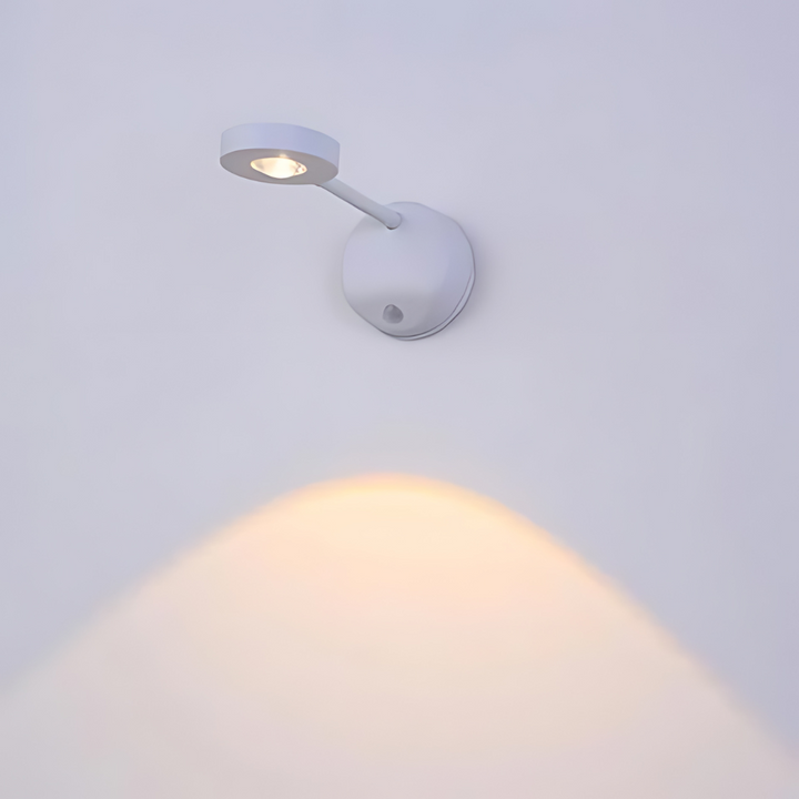 Close-up view of the wireless lamp showing its sleek white casing and motion detection lens.
