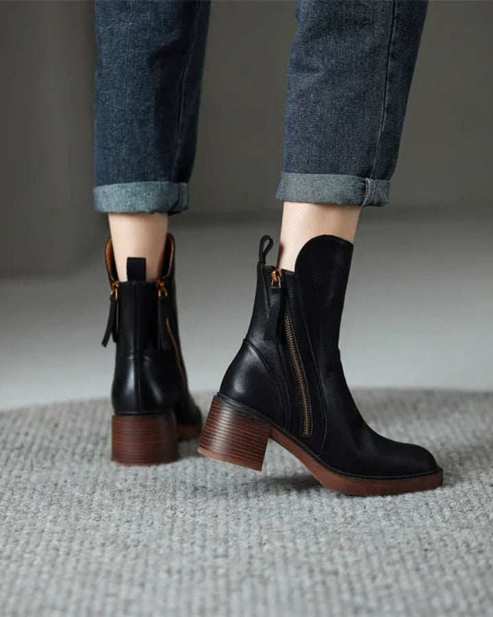 Side profile of women's black ankle boots with a stable block heel