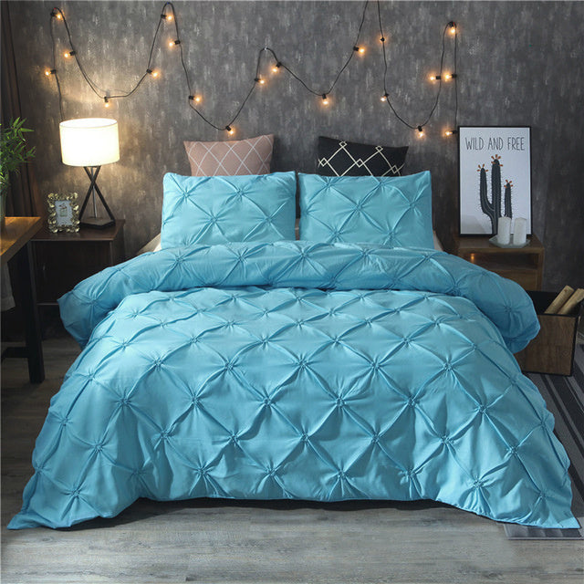 Blue microfiber duvet cover set styled on a modern bed with string lights