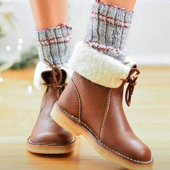 Close-up of women wearing cozy brown ankle boots with warm grey socks