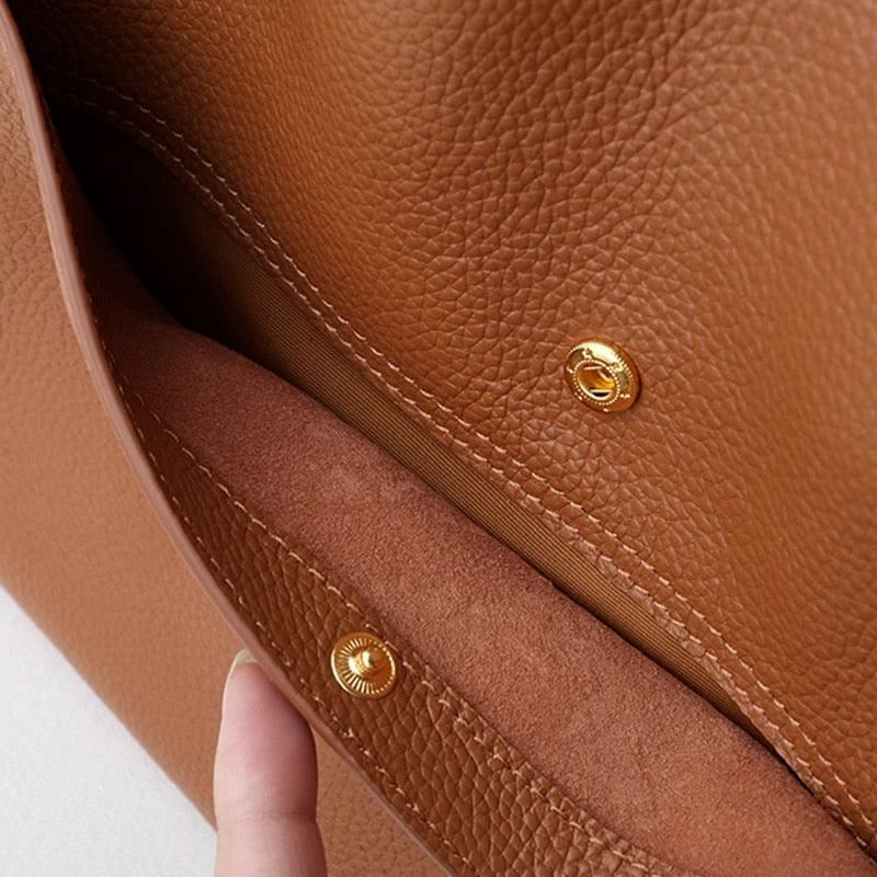 Khaki women's accessory bag featuring structured shape and comfortable straps