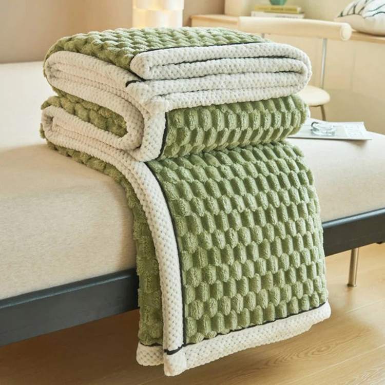 Person relaxing on sofa comfortably covered with a soothing weighted blanket