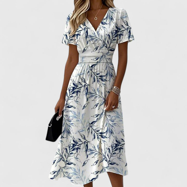 Close-up view of woman wearing white floral wrap midi dress