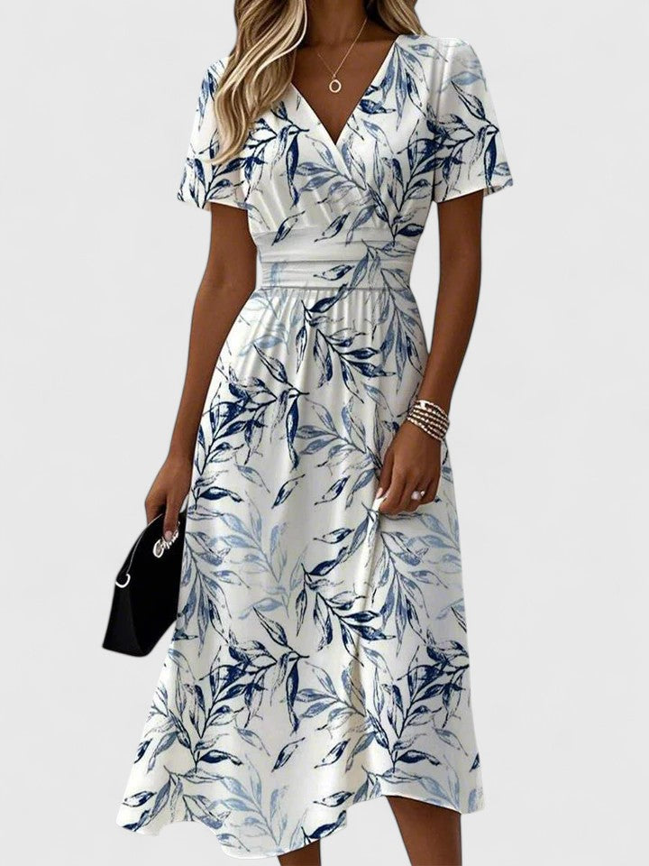 Woman wearing white floral wrap midi dress with V-neck and short sleeves