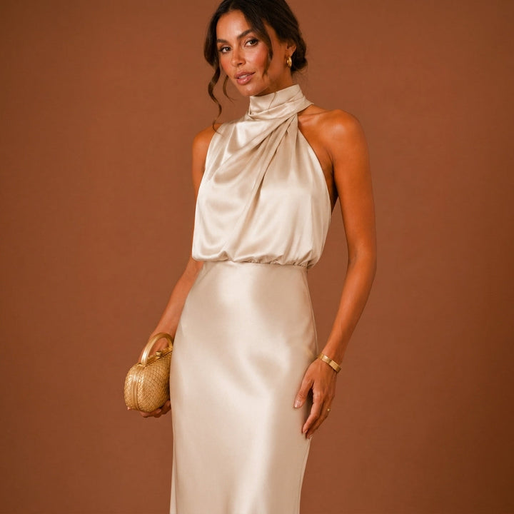 Portrait of a woman wearing an elegant white halter neck maxi dress
