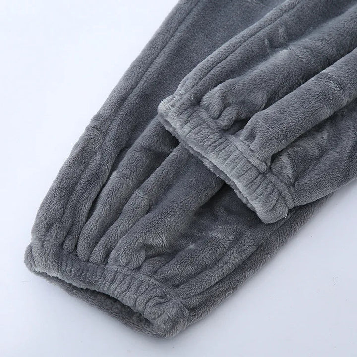 Full view of men's winter pyjamas set laid flat for display