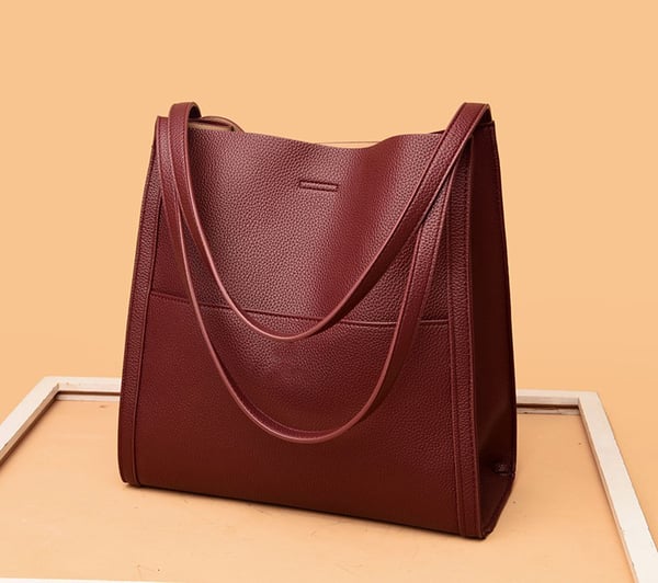 Group of red and black women's luxury handbags displayed together