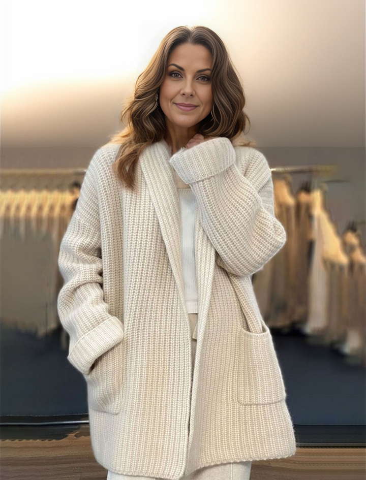 Woman wearing a soft beige knit cardigan with deep pockets