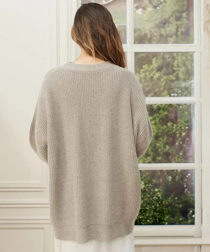 Elegant knitwear cardigan vest featuring ribbed hem and neckline