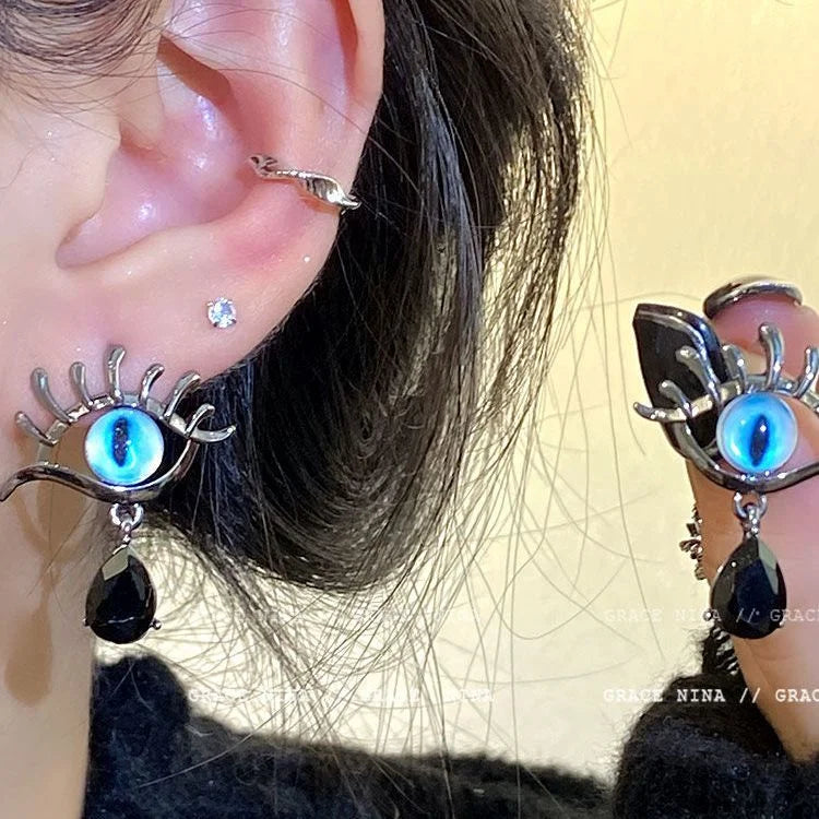 Detailed shot of the evil eye statement earrings worn on ear