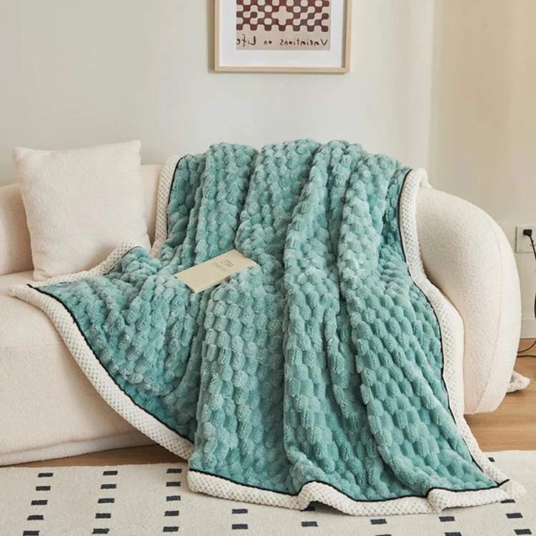 Cozy bedroom styling featuring a weighted sleep aid draped over a plush bed