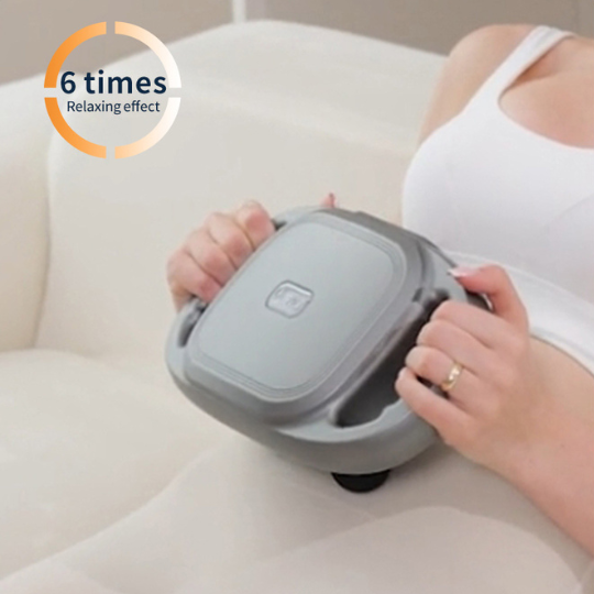Close-up of hands holding the compact white multi-head massage gun