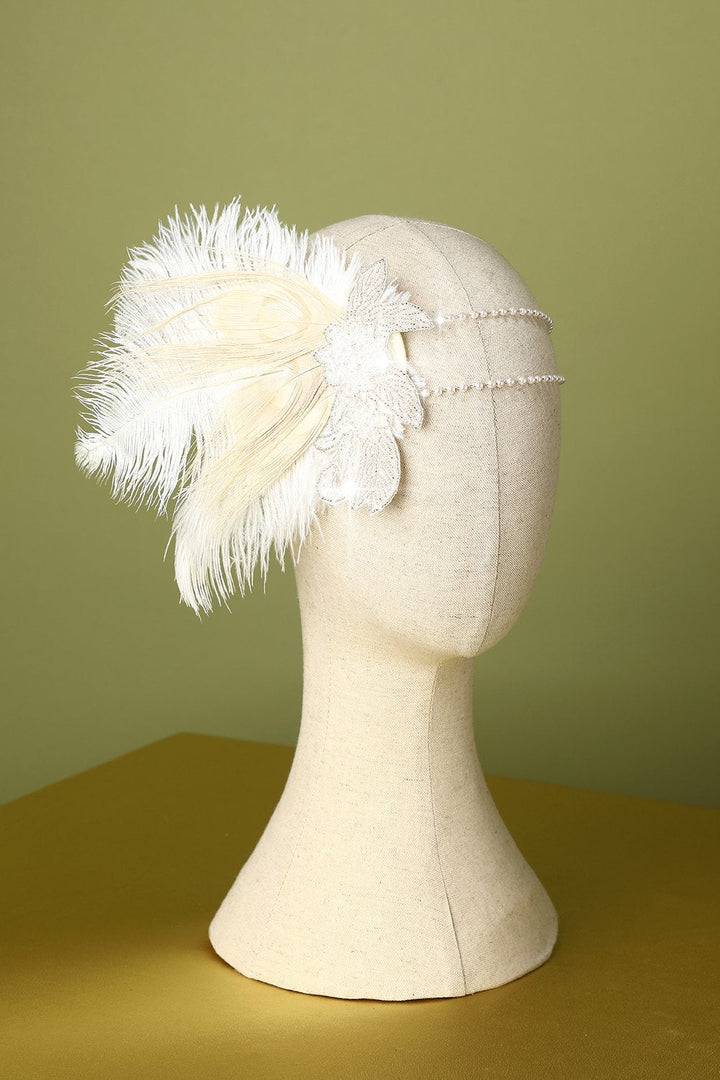 White 1920s feather flapper headband displayed on a mannequin head