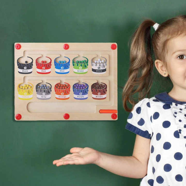 Young girl showing the magnetic number maze board in a classroom setting