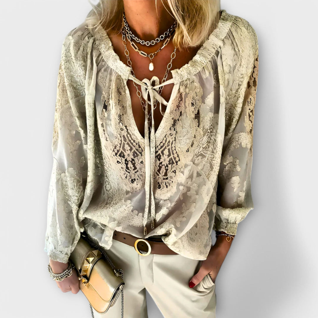 Model wearing beige-khaki lace overlay V-neck blouse with matching trousers