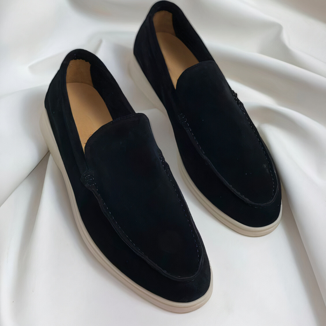 Pair of black men's slip-on casual loafers on white background