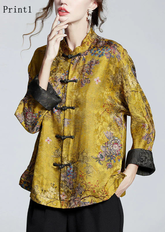 Model wearing gold printed stand-collar coat with black trousers