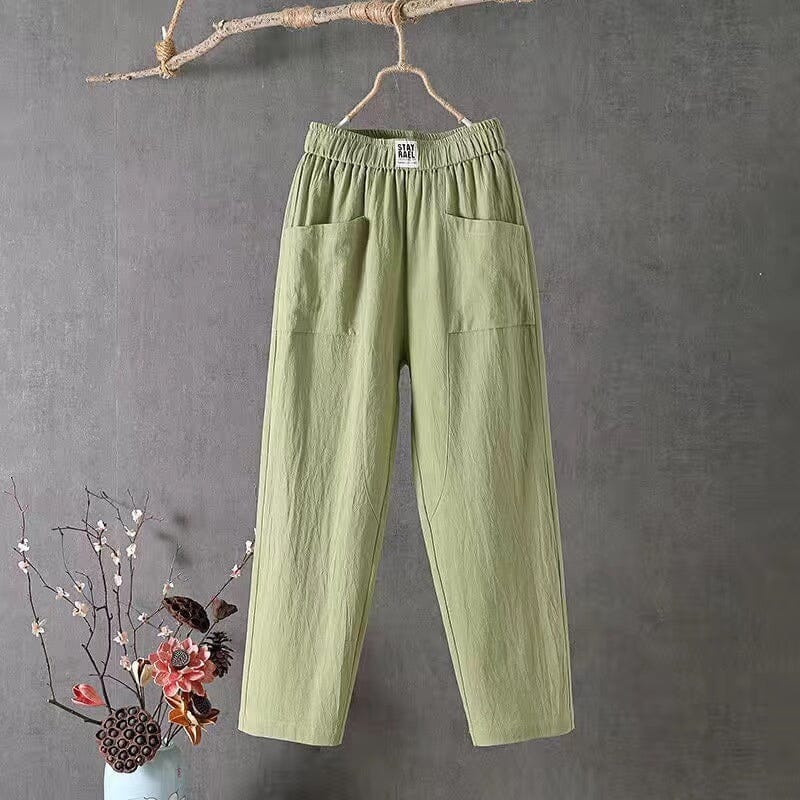 Flat lay of women's elastic waist trousers styled with casual accessories