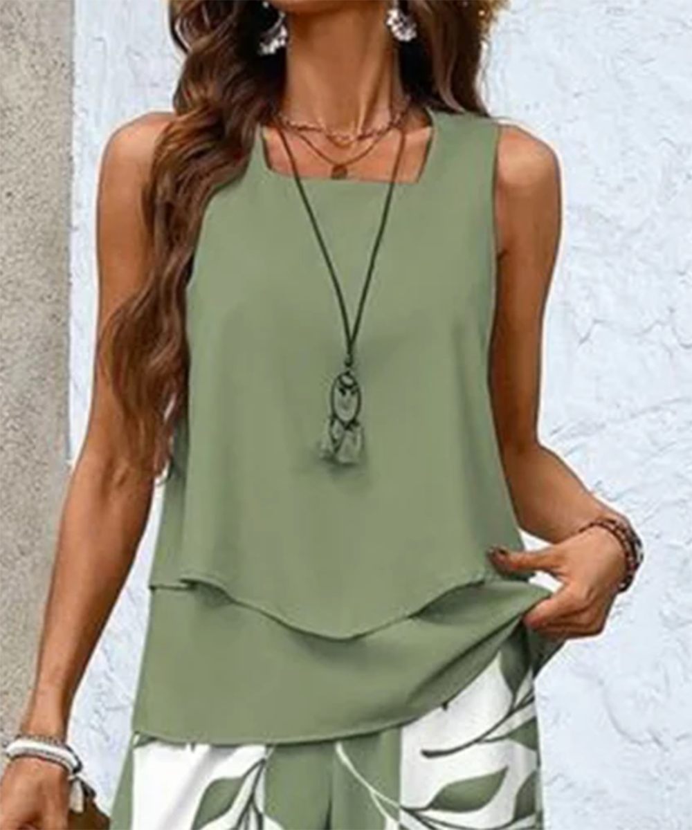Model walking while wearing the elegant leaf print wide leg pants set