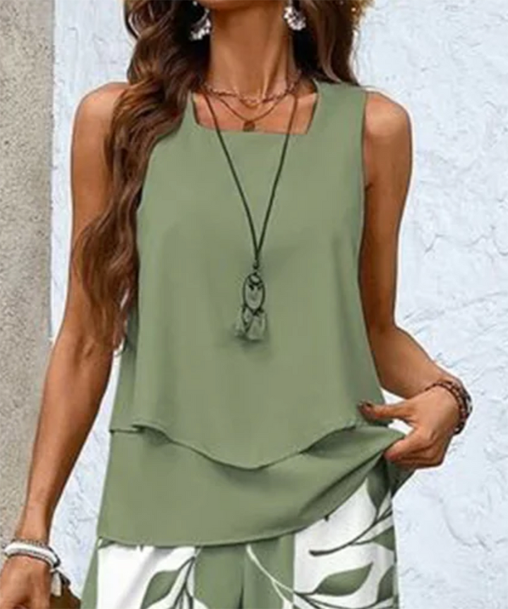 Model walking while wearing the elegant leaf print wide leg pants set