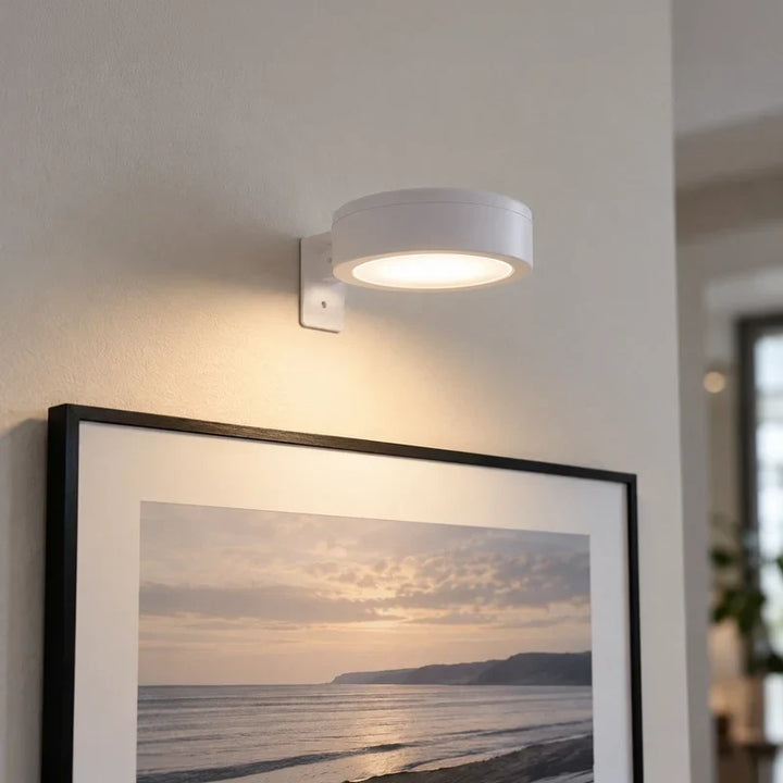 Cordless accent light mounted on a wooden wall panel highlighting displayed certificates
