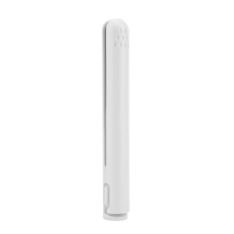 Compact ceramic hair tool demonstrating straightening function on a hair strand