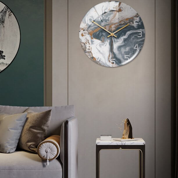 Minimalist living room arrangement featuring the chic marble clock as part of a curated gallery wall.