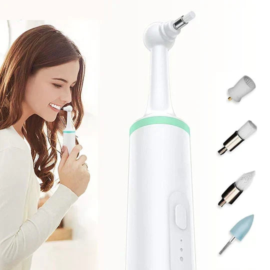 Woman smiling while holding the electric tooth plaque remover with green accent