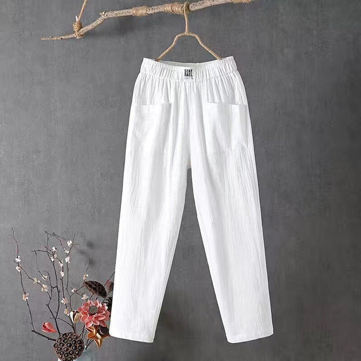 Model wearing solid color casual trousers paired with a basic summer top