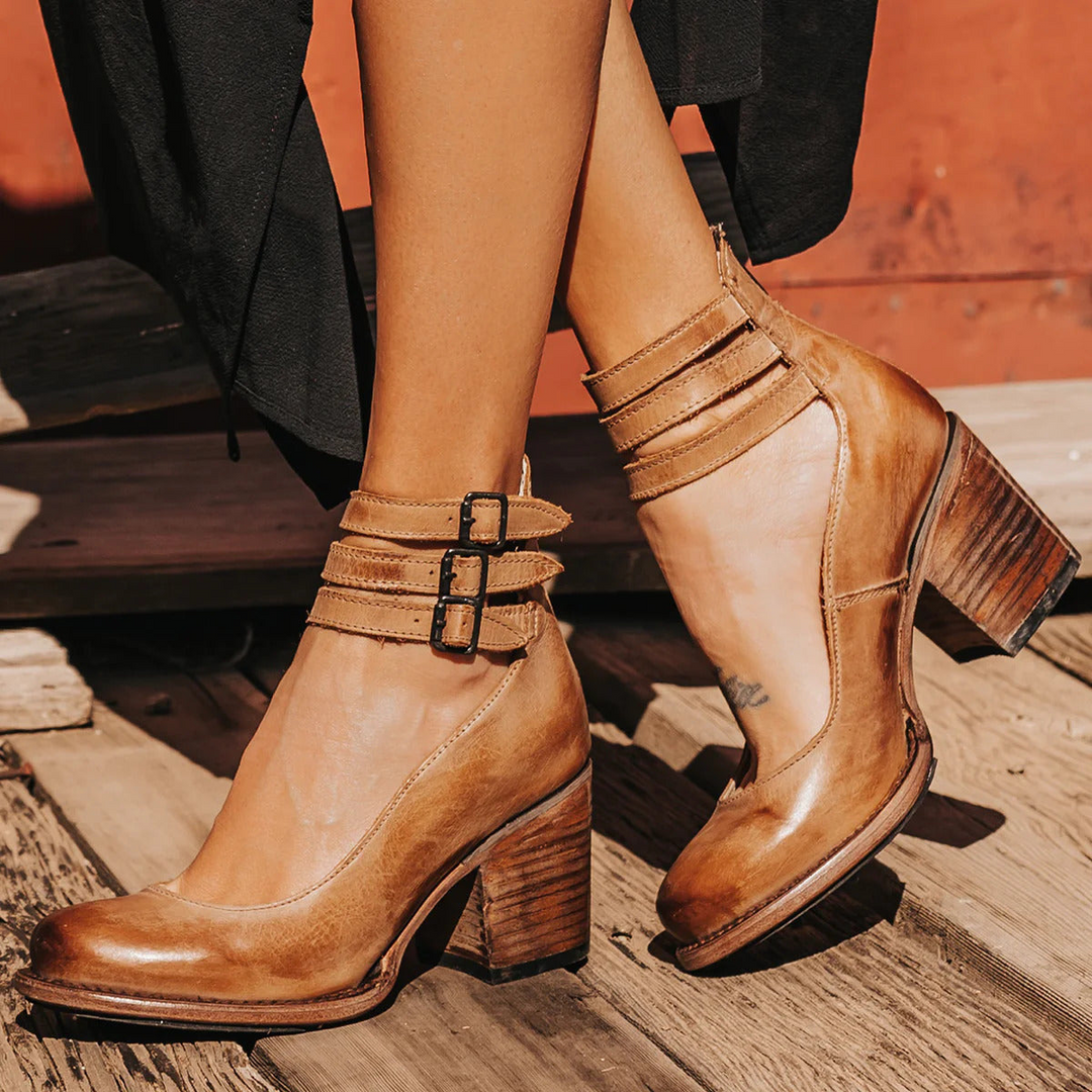 Close-up of brown classic strap heels worn outdoors with block heel
