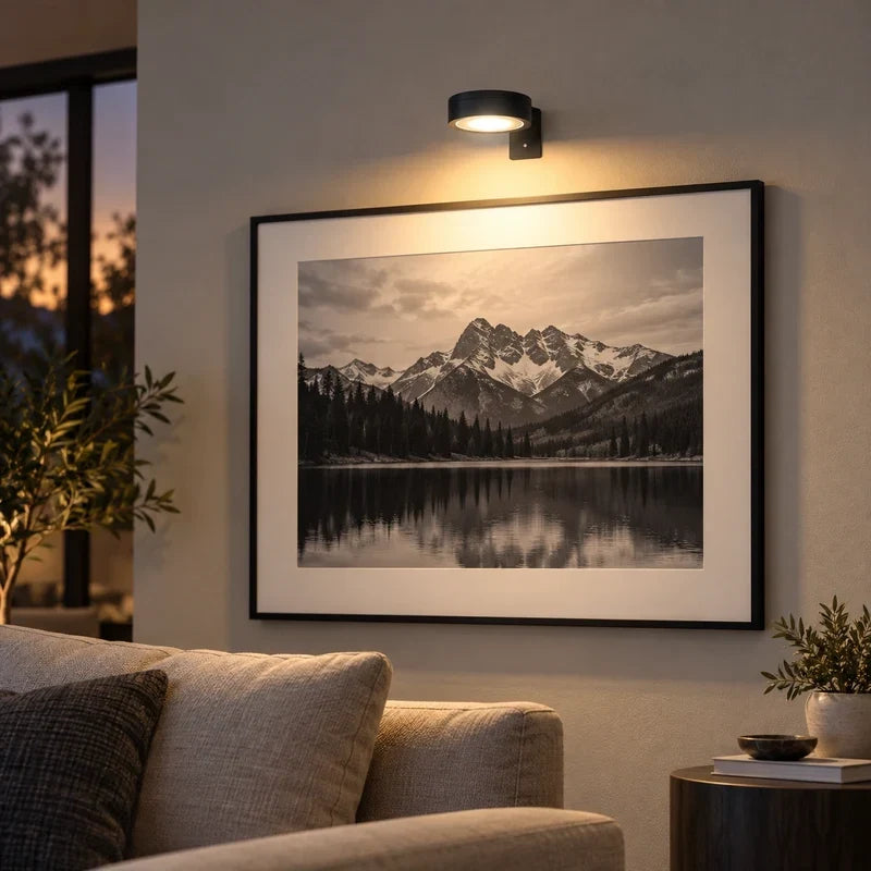 Wireless art lighting fixture mounted above a painting showcasing warm LED accent light