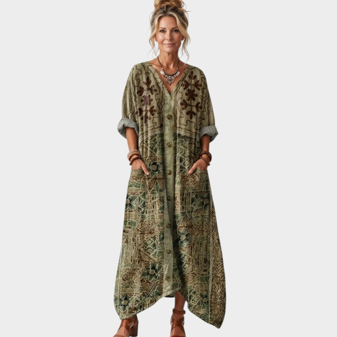 Front view of a woman wearing a green boho maxi dress with front buttons and embroidery