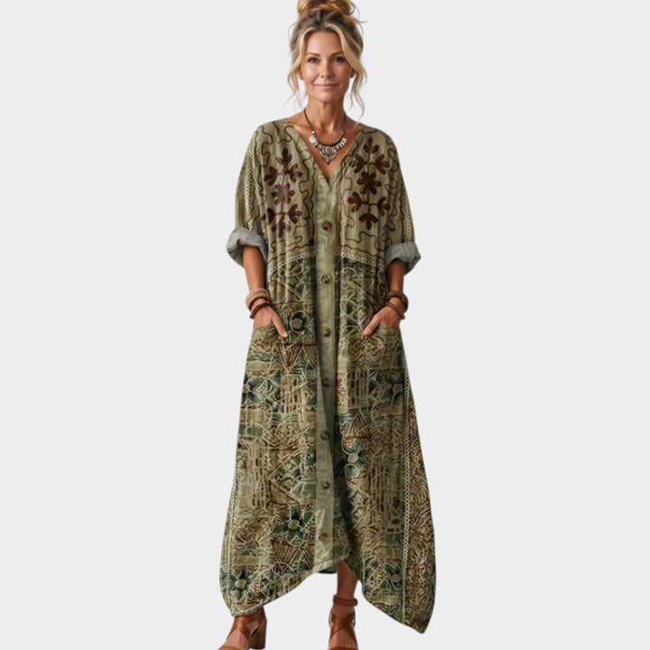Front view of a woman wearing a green boho maxi dress with front buttons and embroidery