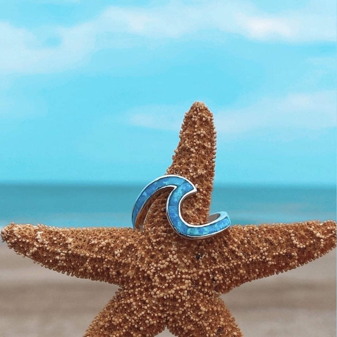 Summer statement silver ring featuring blue opal wave design