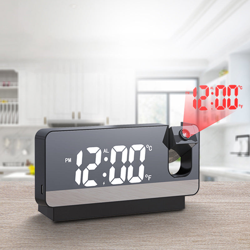 Black projection alarm clock displaying time on wall