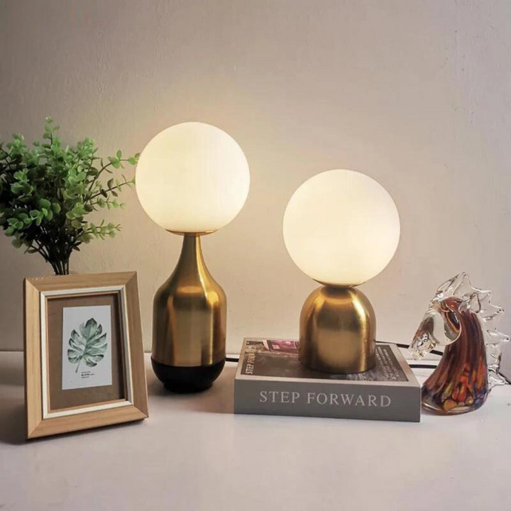 Nordic Globe Table Lamps in two sizes displayed on a table with books and decor