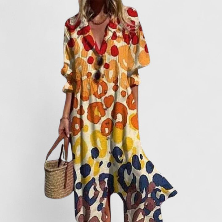 Woman wearing patterned yellow and red maxi shirt dress
