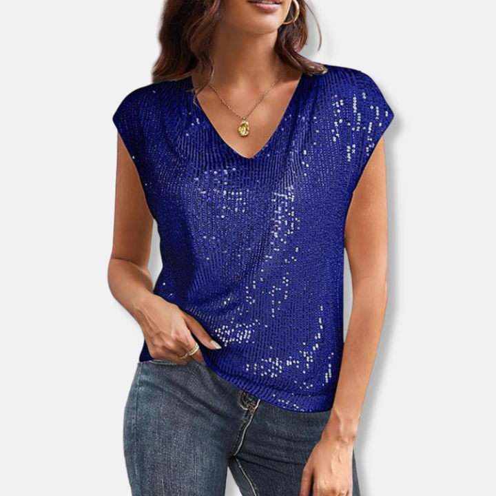 Woman wearing royal blue sparkly sequin V-neck top with cap sleeves