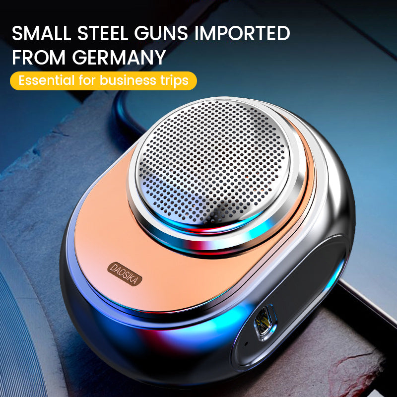 Mini portable electric shaver in silver finish on a dark surface
