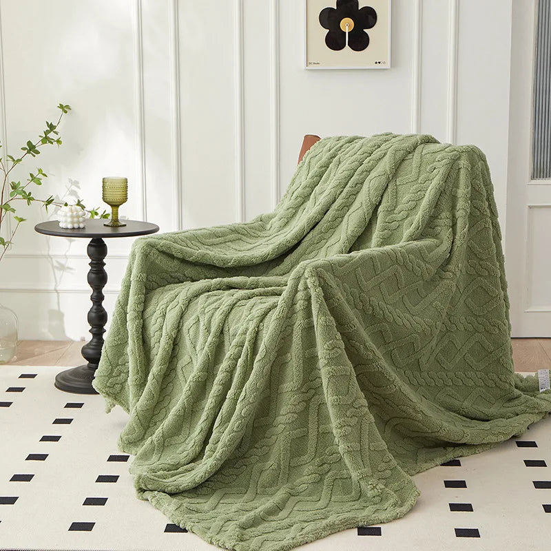 Cozy green plush blanket draped over an armchair in a bright living room