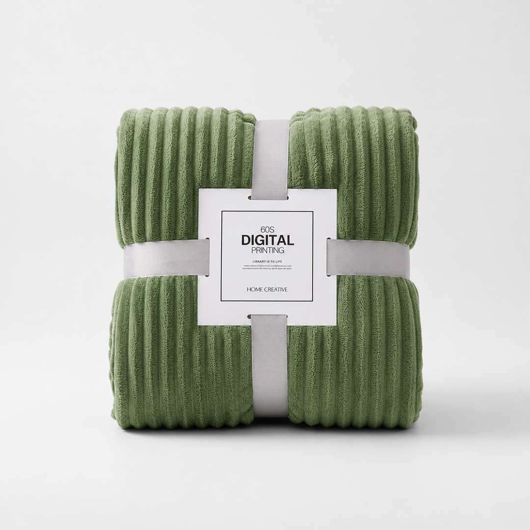 Folded green coral velvet throw blanket packaged with a decorative label