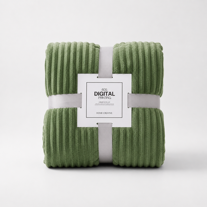 Folded green coral velvet throw blanket packaged with a decorative label