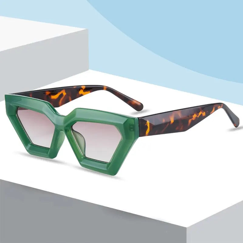 Green geometric designer sunglasses on a white surface