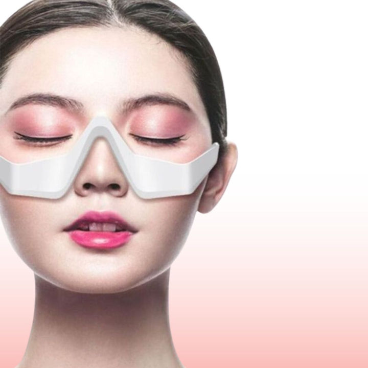 Woman wearing white under-eye massager device on her face