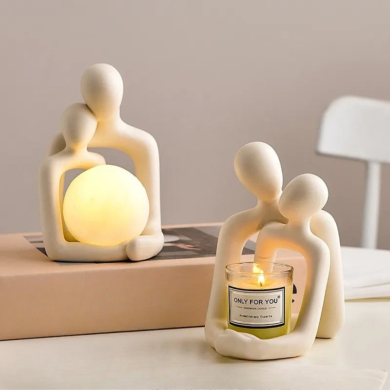 Ceramic couple mood light showcasing warm glowing orb and decorative candle holder