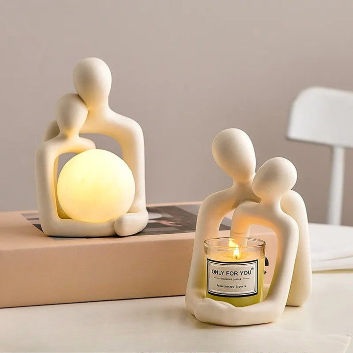 Ceramic couple mood light showcasing warm glowing orb and decorative candle holder