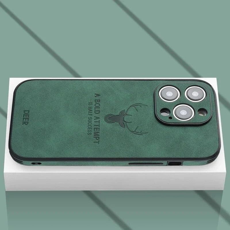 Dark green textured iPhone case resting on a white box showing camera cutout