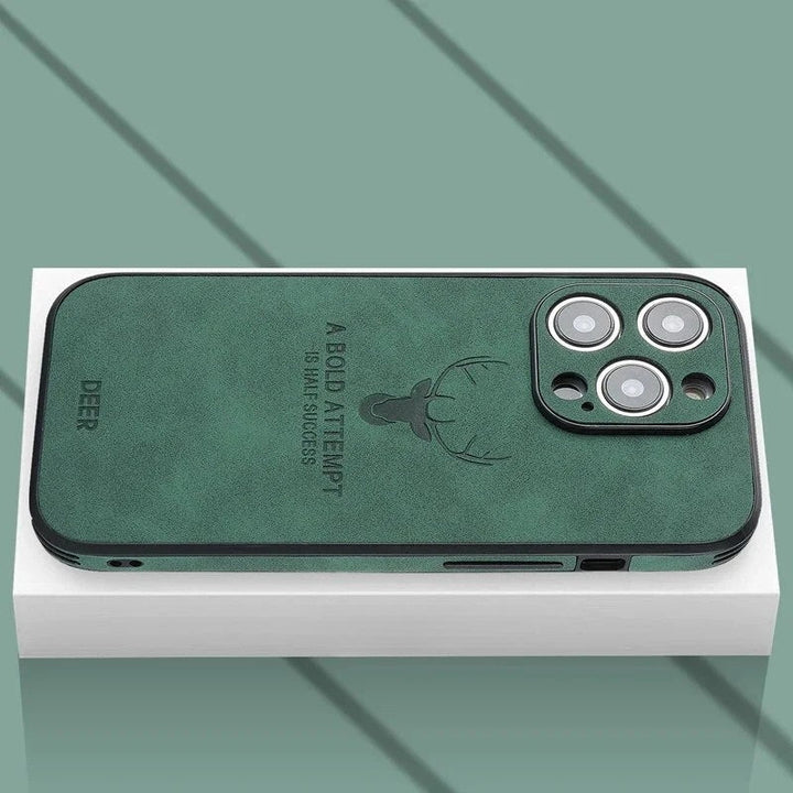 Dark green textured iPhone case resting on a white box showing camera cutout